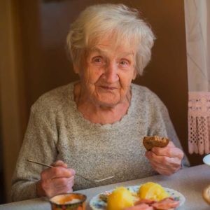 Elderly Woman Eating Meal